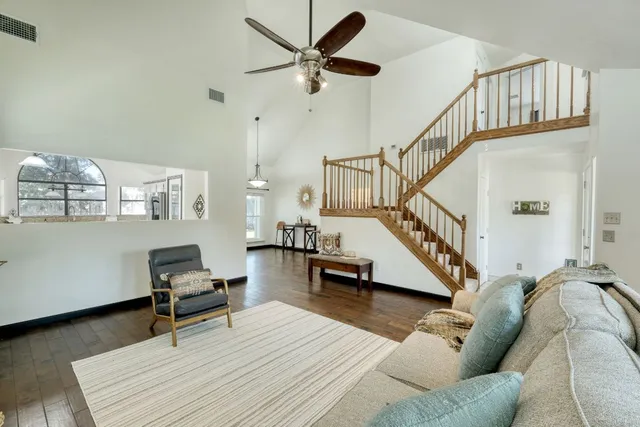 a living room with furniture and a wooden floor