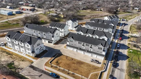 an aerial view of residential houses with outdoor space
