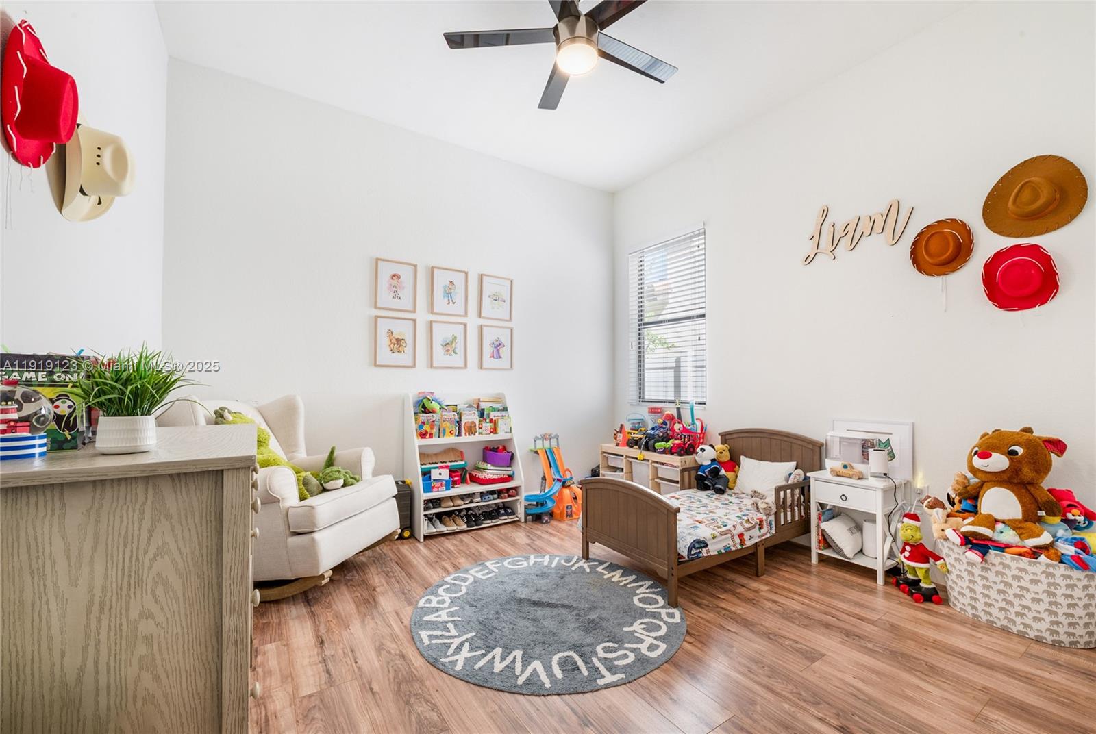 3550 West 86th Terrace, Unit 3550 Hialeah, FL 33018 - Photo 13 of 17 a living room with furniture and a wooden floor