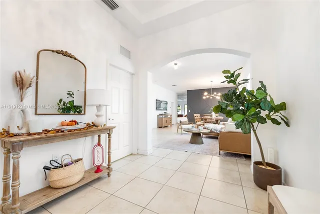 a living room with furniture and a potted plant