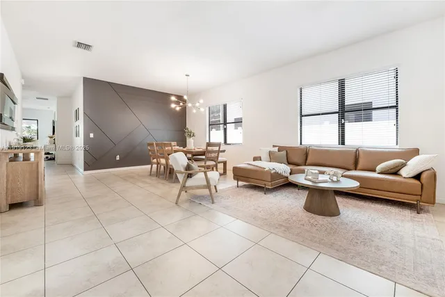 a living room with furniture and a large window