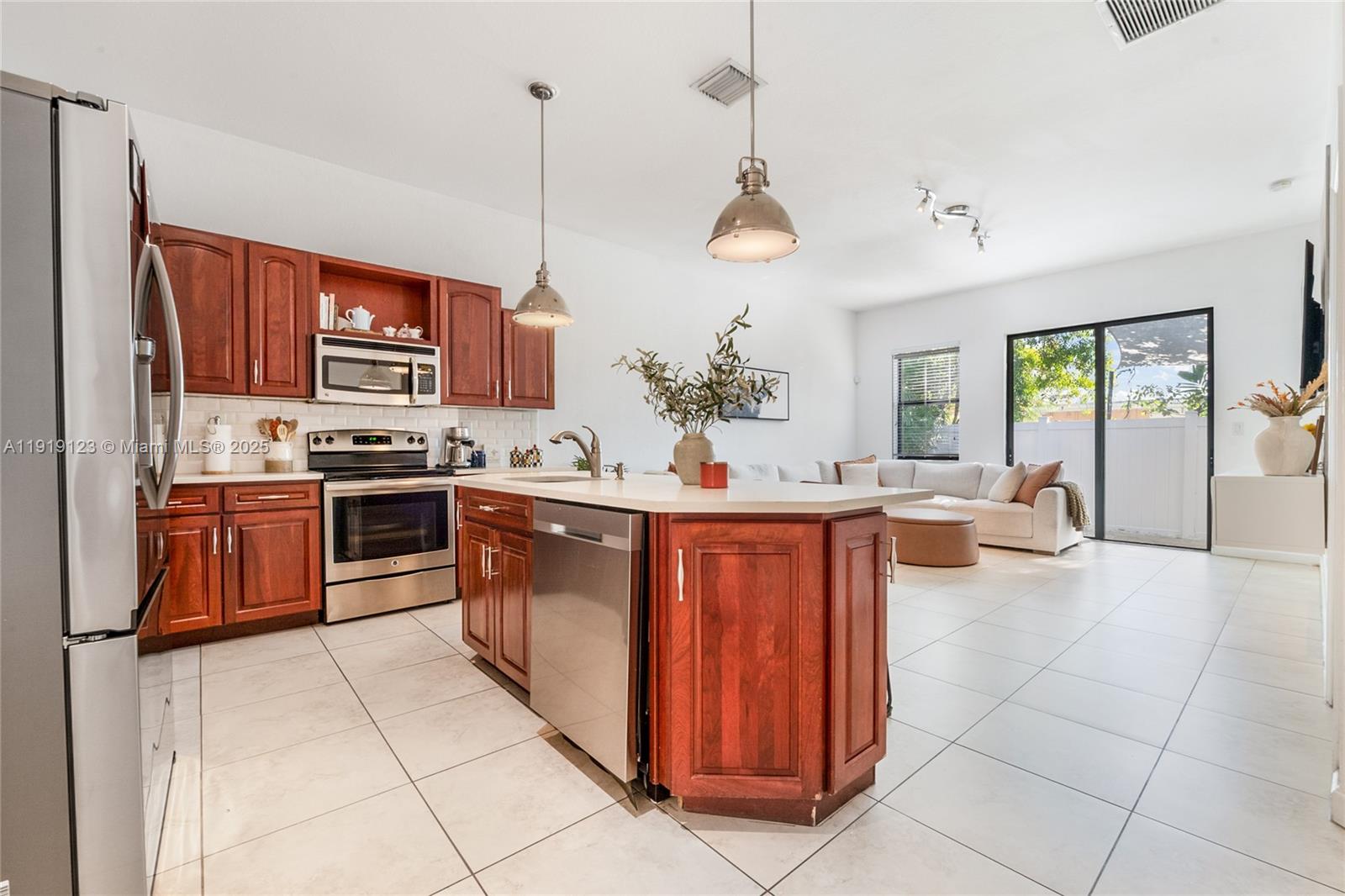3550 West 86th Terrace, Unit 3550 Hialeah, FL 33018 - Photo 7 of 17 a kitchen with stainless steel appliances granite countertop a stove a sink dishwasher and a refrigerator