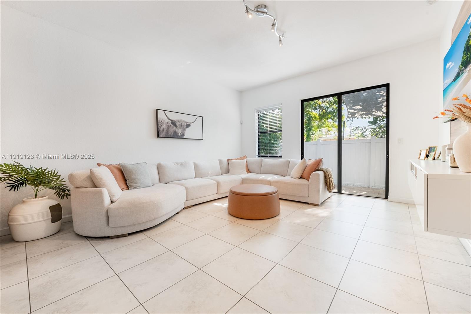 3550 West 86th Terrace, Unit 3550 Hialeah, FL 33018 - Photo 9 of 17 a living room with furniture and a potted plant
