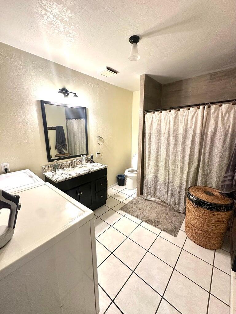 401 Xenia Street Plainview, TX 79072 - Photo 15 of 20 a bedroom with a bed and a view of bathroom