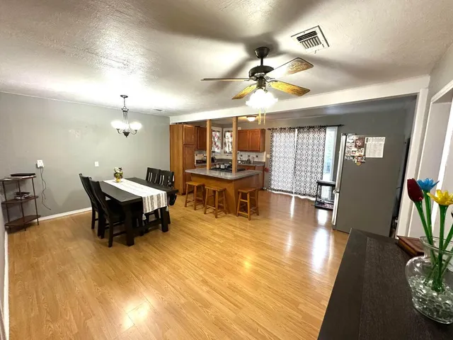 a living room with dining room furniture and a large window
