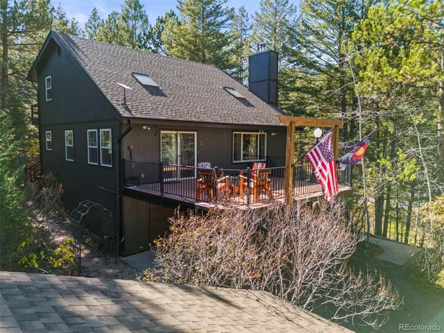 a view of a chairs and table on the wooden deck