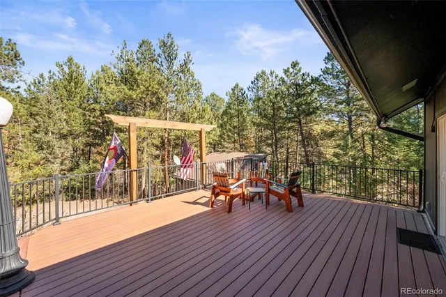 a spacious bedroom with a bed and a chandelier