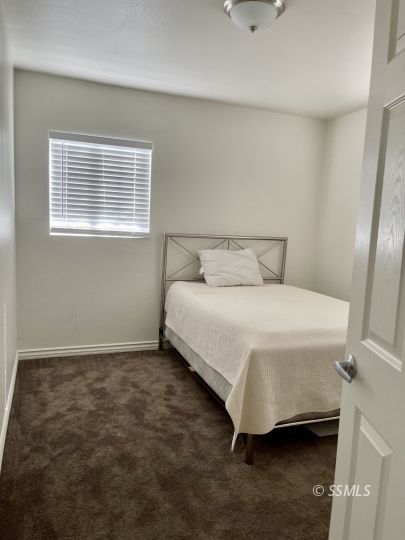 305 North Fairview Street Ridgecrest, CA 93555 - Photo 9 of 17 a bedroom with a bed and a window