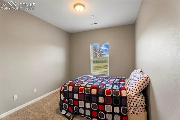 a bedroom with bed and a window