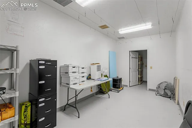 a room with a chair and gym equipment