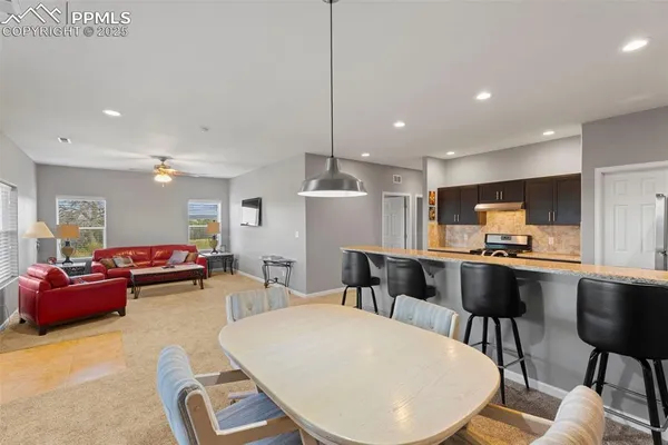 a living room with furniture and kitchen view