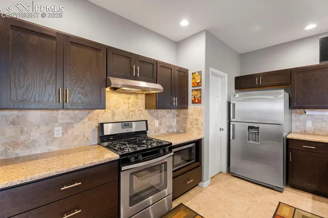 a kitchen with a stove and a refrigerator