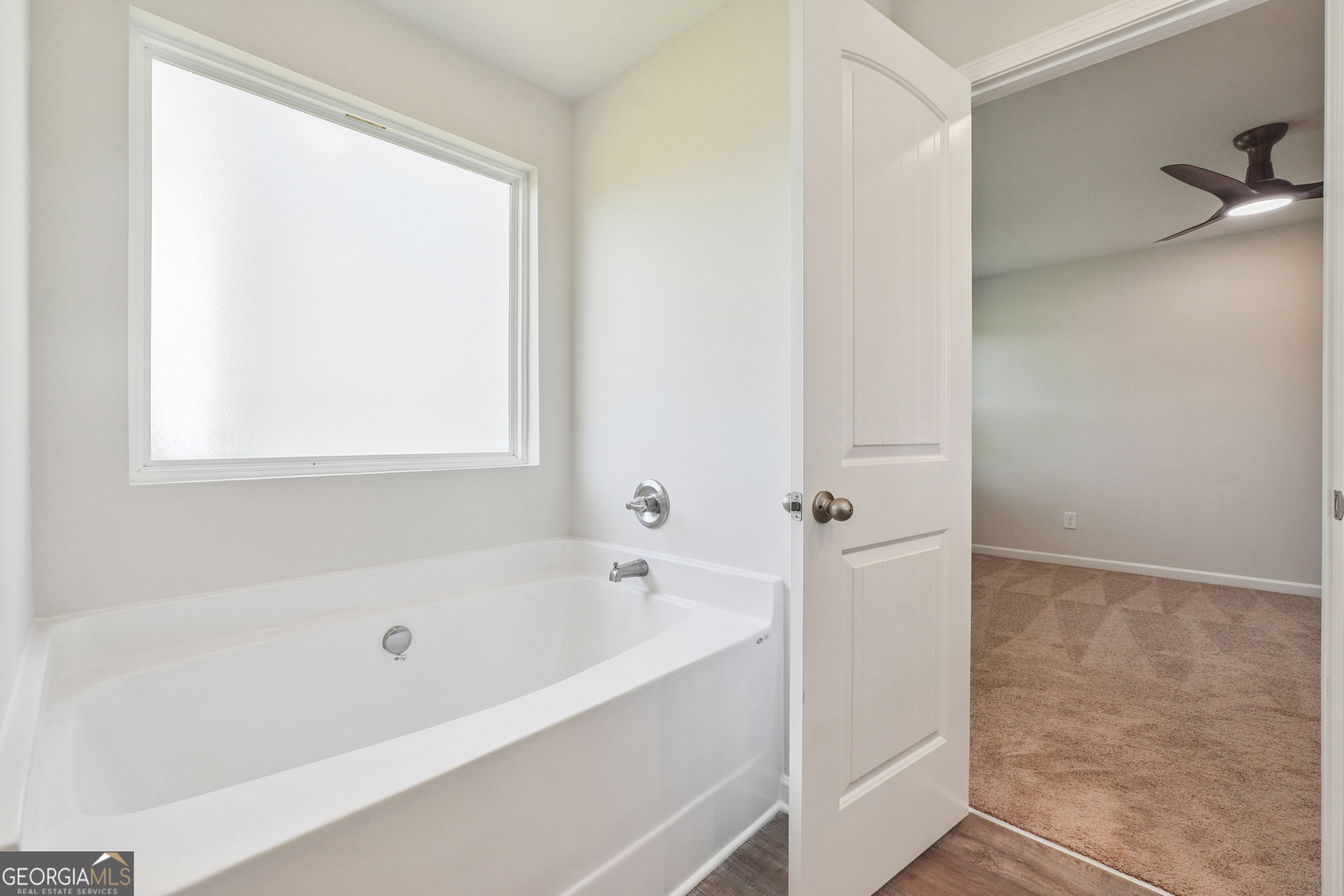 210 Harris Walk, Unit 79 Cataula, GA 31804 - Photo 14 of 22 a white bath tub sitting next to a window