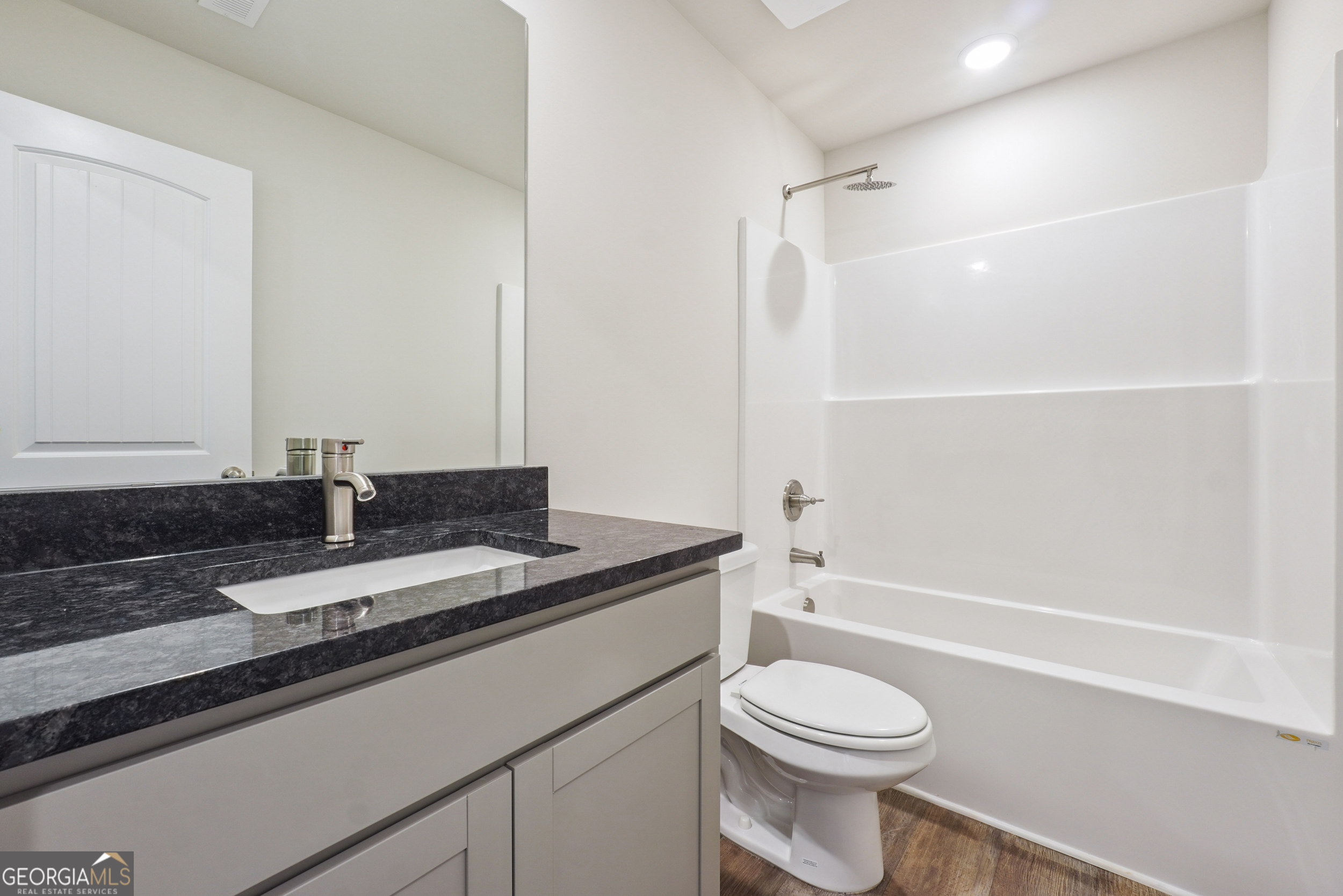 210 Harris Walk, Unit 79 Cataula, GA 31804 - Photo 21 of 22 a bathroom with a granite countertop sink toilet and shower
