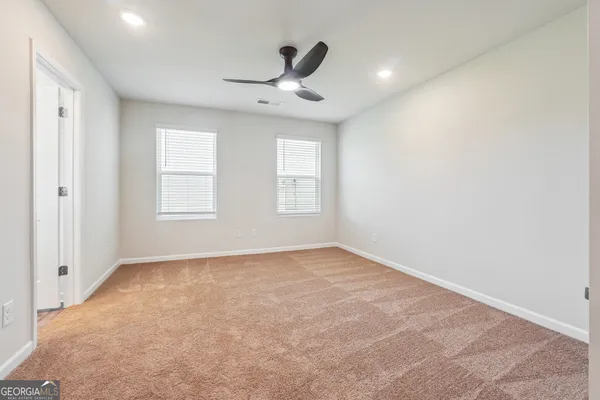 an empty room with windows and closet