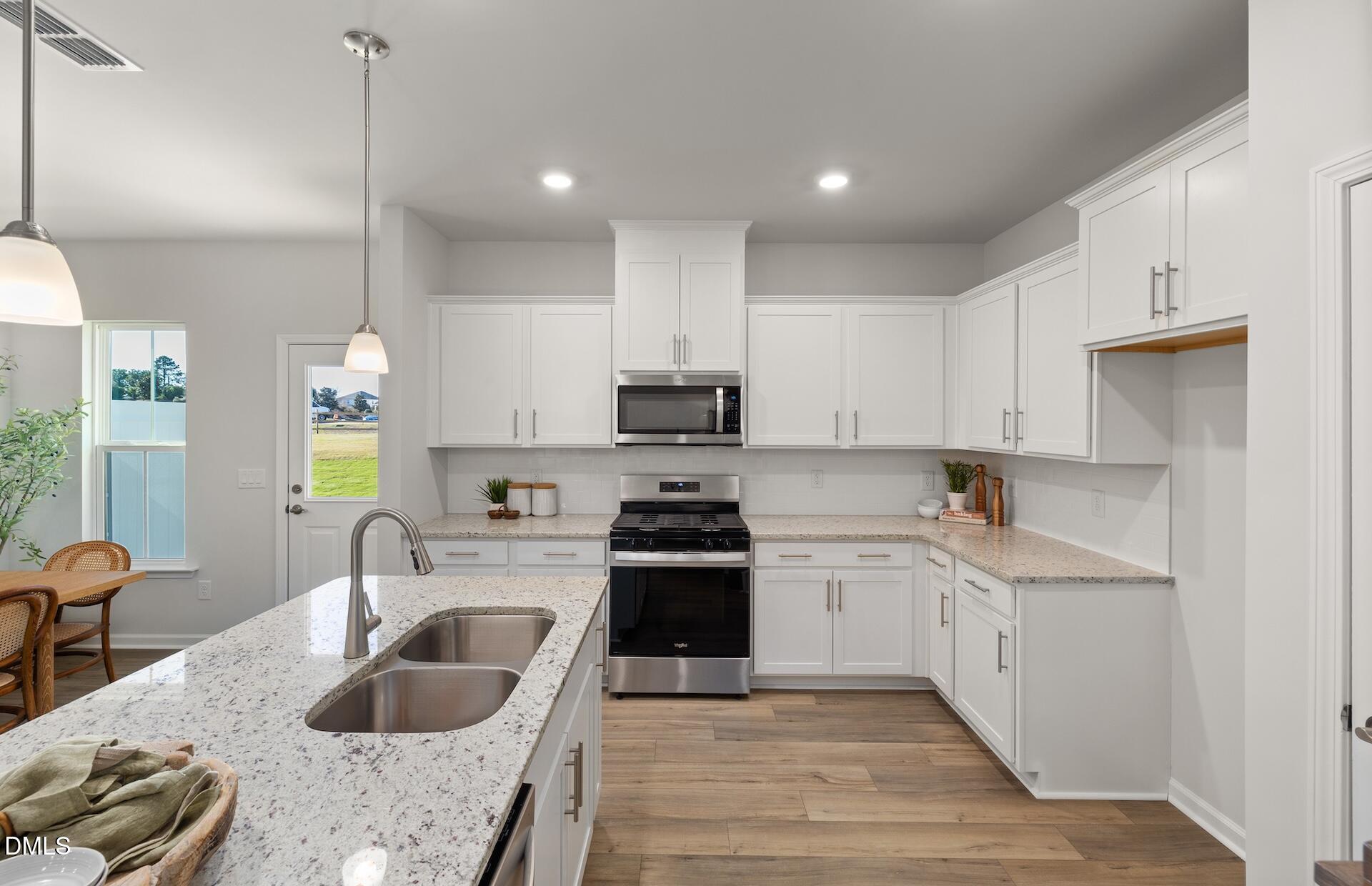 2814 Rodeo Court Fuquay-Varina, NC 27526 - Photo 5 of 31 a kitchen with stainless steel appliances granite countertop a sink stove and refrigerator