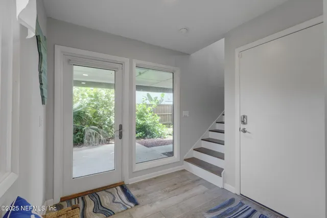 a living room with furniture and large windows