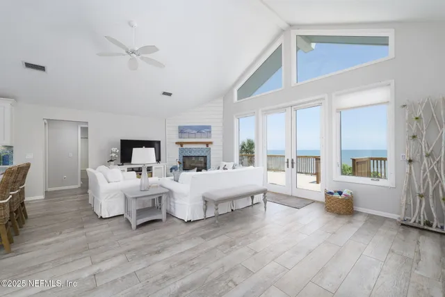 a living room with furniture large window and a fireplace