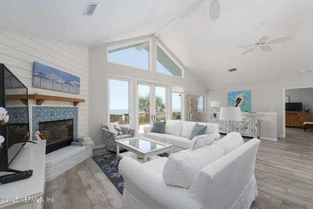 a kitchen with stainless steel appliances granite countertop a refrigerator a stove a microwave oven a dining table and chairs