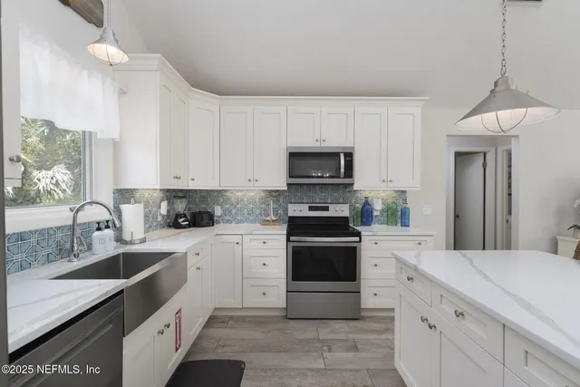 a dining room with furniture a chandelier and wooden floor