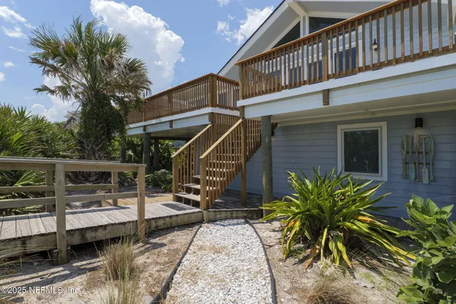 a view of a patio with table and chairs and potted plants