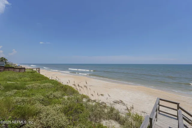 a front view of a house with a yard and balcony