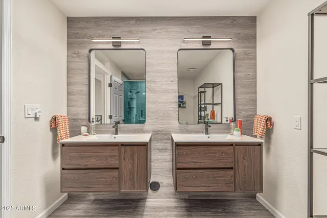 a bathroom with a double vanity sink and mirror
