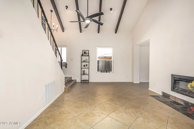 a view of a livingroom with wooden floor and staircase