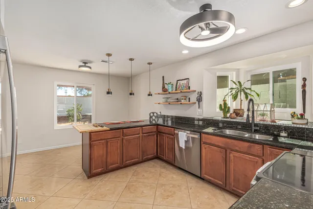 a kitchen with stainless steel appliances granite countertop a sink and stove