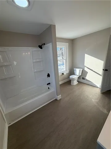 a spacious bathroom with a bathtub and shower