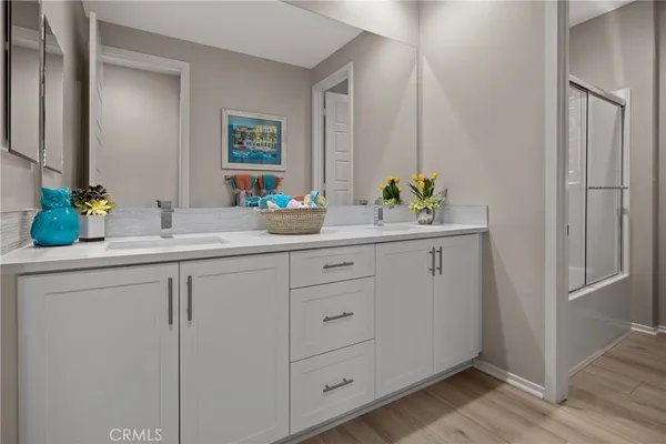 a bathroom with a double vanity sink and a mirror