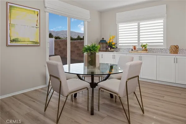 a view of a dining room with furniture and window