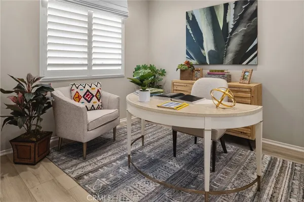 a view of a workspace with furniture and a potted plant