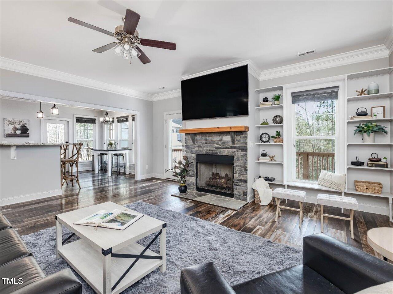 406 Gum Springs Church Road Moncure, NC 27559 - Photo 20 of 100 a living room with furniture a flat screen tv and a fireplace