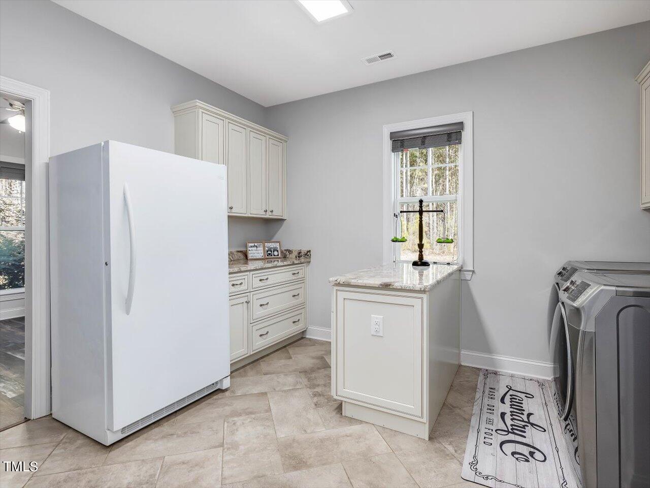 406 Gum Springs Church Road Moncure, NC 27559 - Photo 35 of 100 a kitchen with stainless steel appliances a refrigerator sink and cabinets
