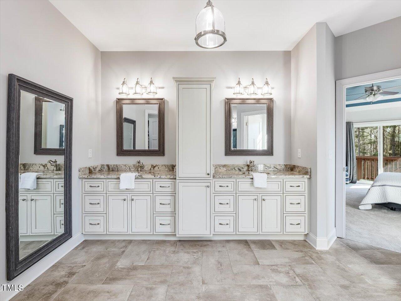 406 Gum Springs Church Road Moncure, NC 27559 - Photo 41 of 100 a spacious bathroom with double vanity sinks a mirror a vanity and a