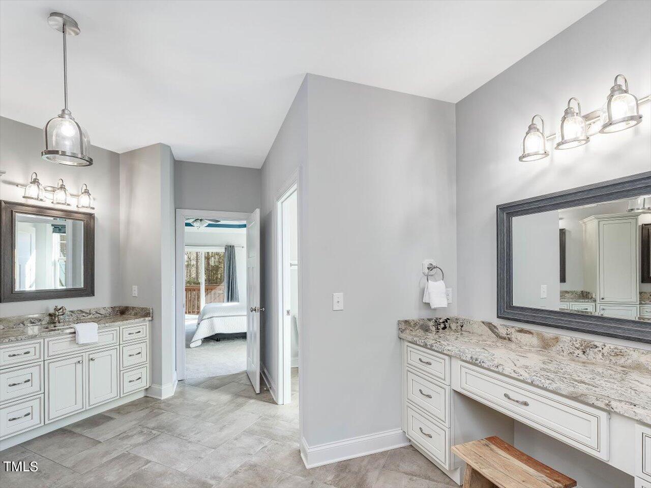 406 Gum Springs Church Road Moncure, NC 27559 - Photo 44 of 100 a bathroom with double vanity sink and a mirror