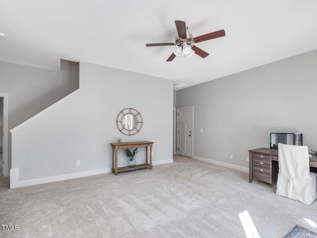406 Gum Springs Church Road Moncure, NC 27559 - Photo 50 of 100 a view of a room with a wooden floor and a ceiling fan