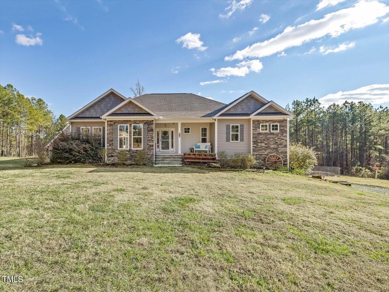 406 Gum Springs Church Road Moncure, NC 27559 - Photo 5 of 100 a front view of a house with a garden