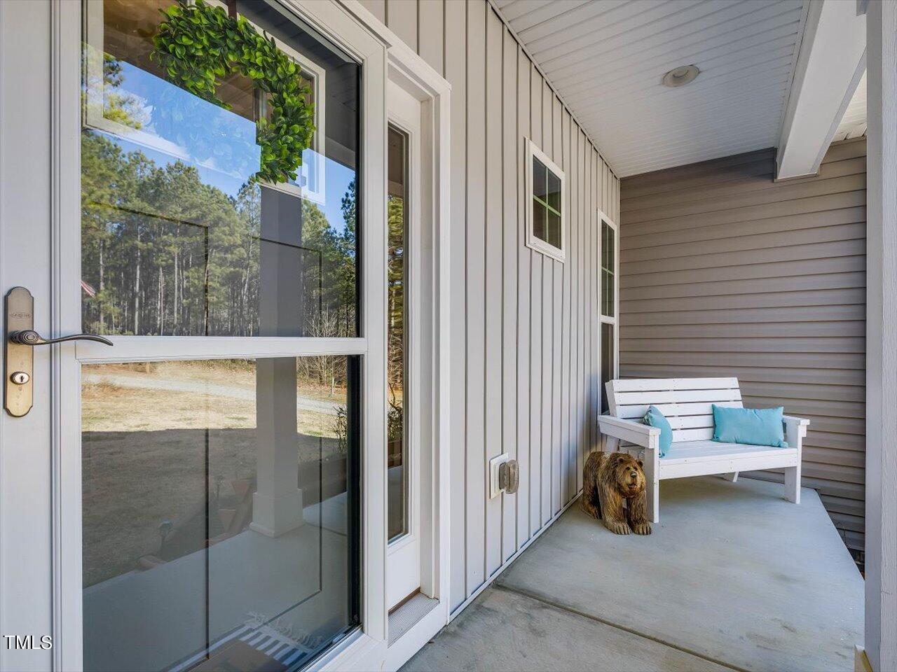 406 Gum Springs Church Road Moncure, NC 27559 - Photo 9 of 100 a view of a balcony with chair and glass door