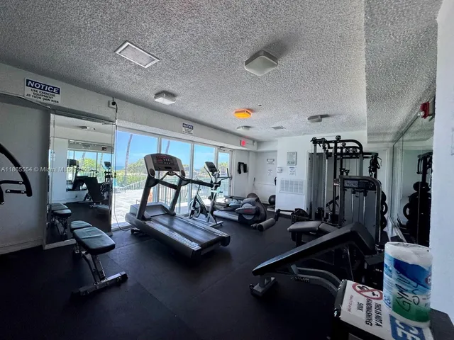 an aerial view of a residential apartment building with a yard and plants