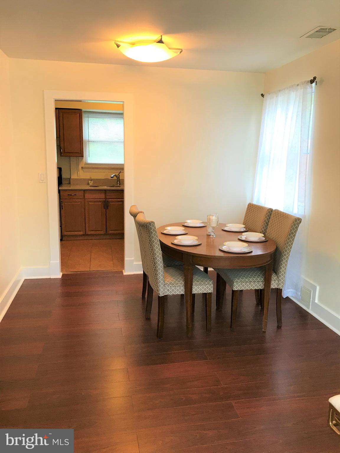 2419 Darrow Street Silver Spring, MD 20902 - Photo 7 of 33 a view of a dining room with furniture and wooden floor