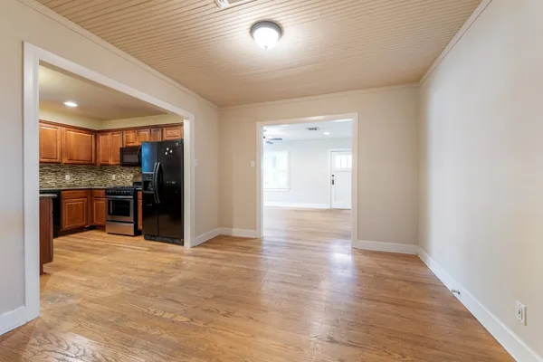 a view of a kitchen with a sink and stainless steel appliances