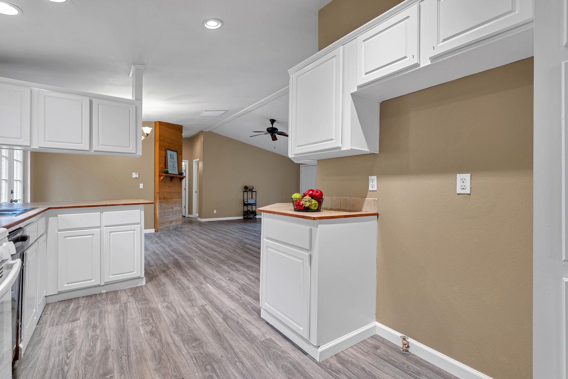 22150 Ravine Court Redding, CA 96003 - Photo 11 of 37 a kitchen with granite countertop white cabinets and wooden floor