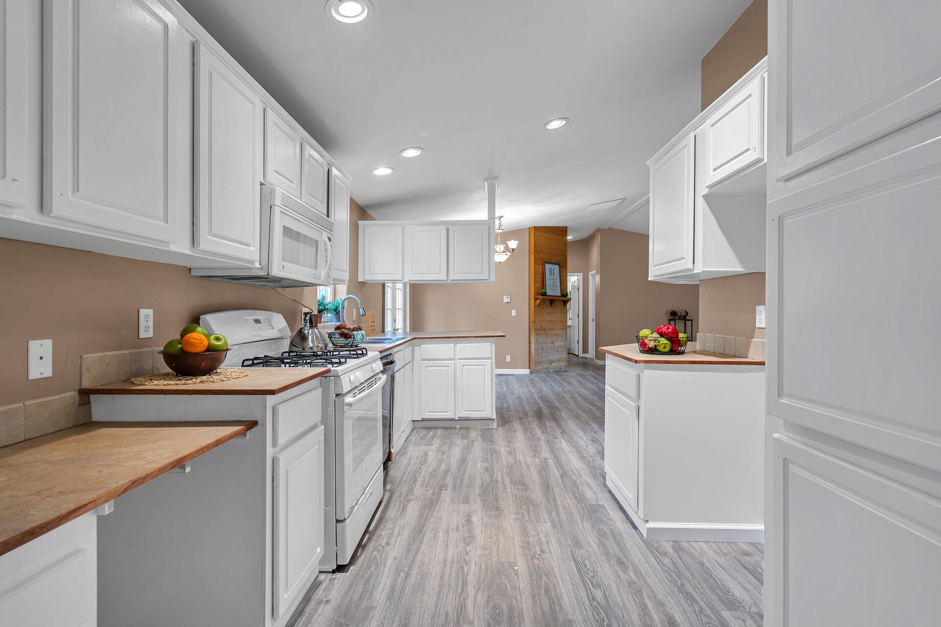 22150 Ravine Court Redding, CA 96003 - Photo 15 of 37 a kitchen with granite countertop a sink stove and cabinets