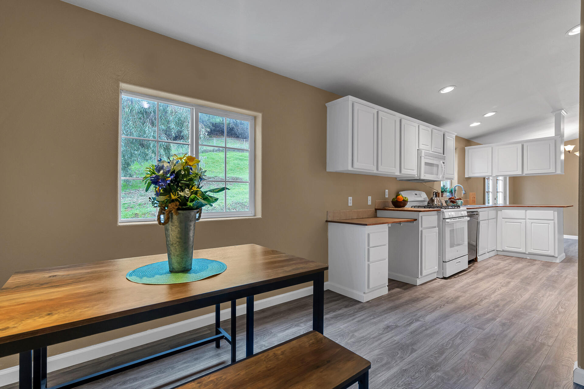 22150 Ravine Court Redding, CA 96003 - Photo 17 of 37 a kitchen with a table and chairs