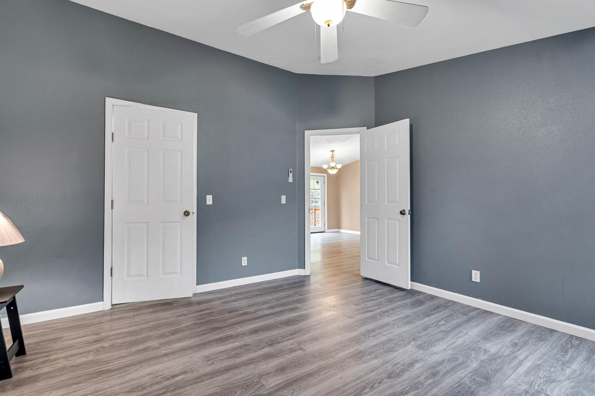 22150 Ravine Court Redding, CA 96003 - Photo 20 of 37 an empty room with wooden floor and ceiling fan