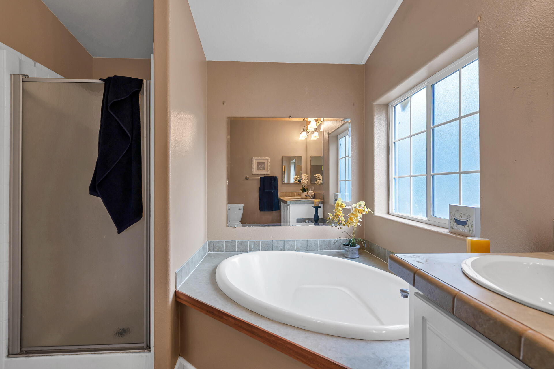 22150 Ravine Court Redding, CA 96003 - Photo 22 of 37 a bathroom with a sink and a large mirror