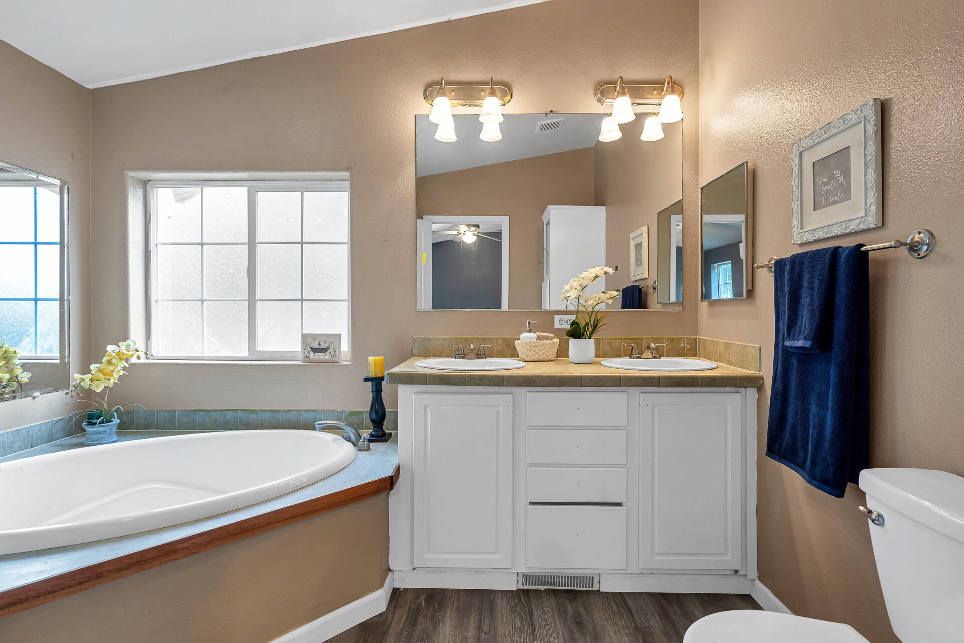 22150 Ravine Court Redding, CA 96003 - Photo 23 of 37 a bathroom with a tub a sink and a large mirror