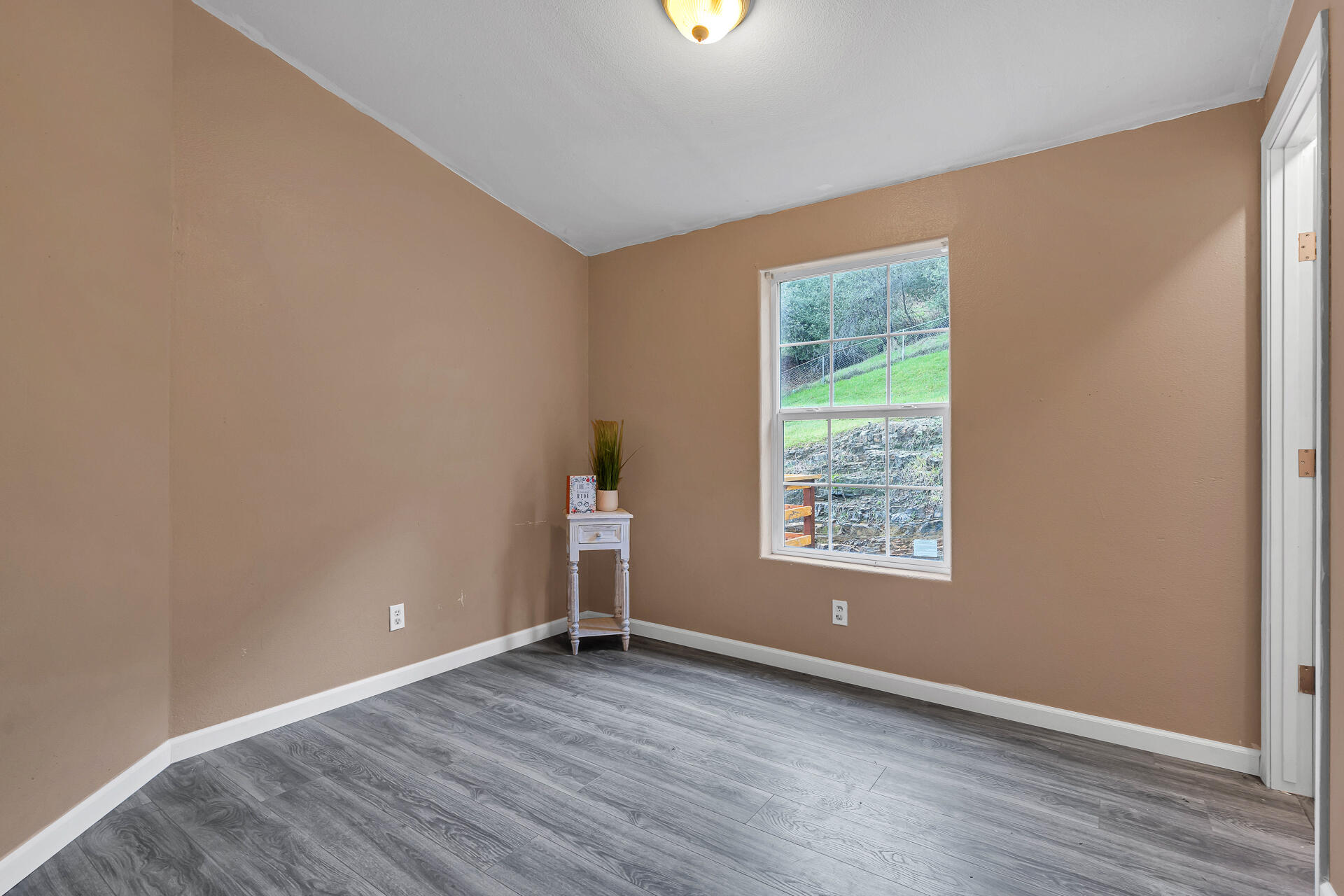 22150 Ravine Court Redding, CA 96003 - Photo 24 of 37 an empty room with wooden floor and windows